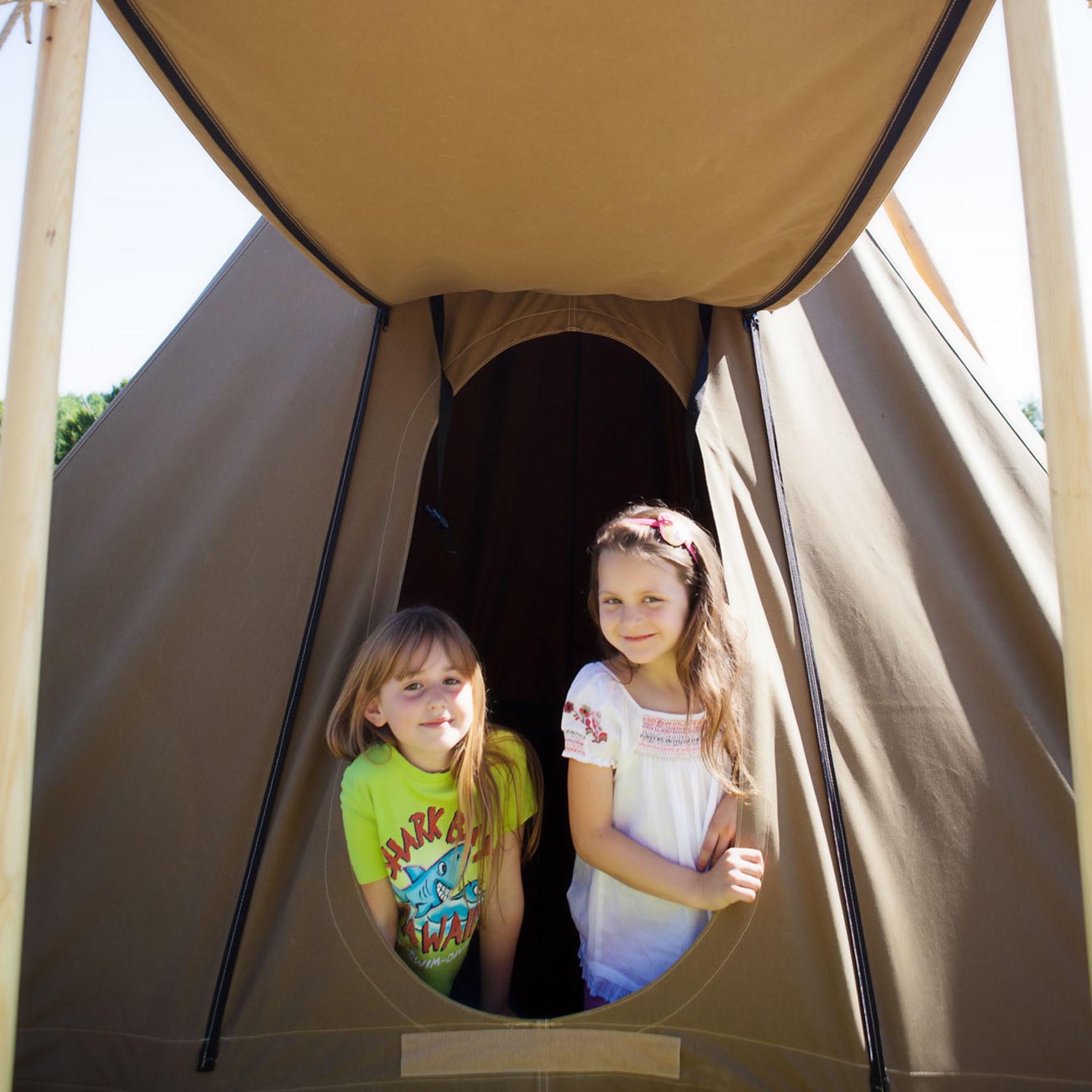 Two young girls in a teepee at Durrell Wildlife Camp