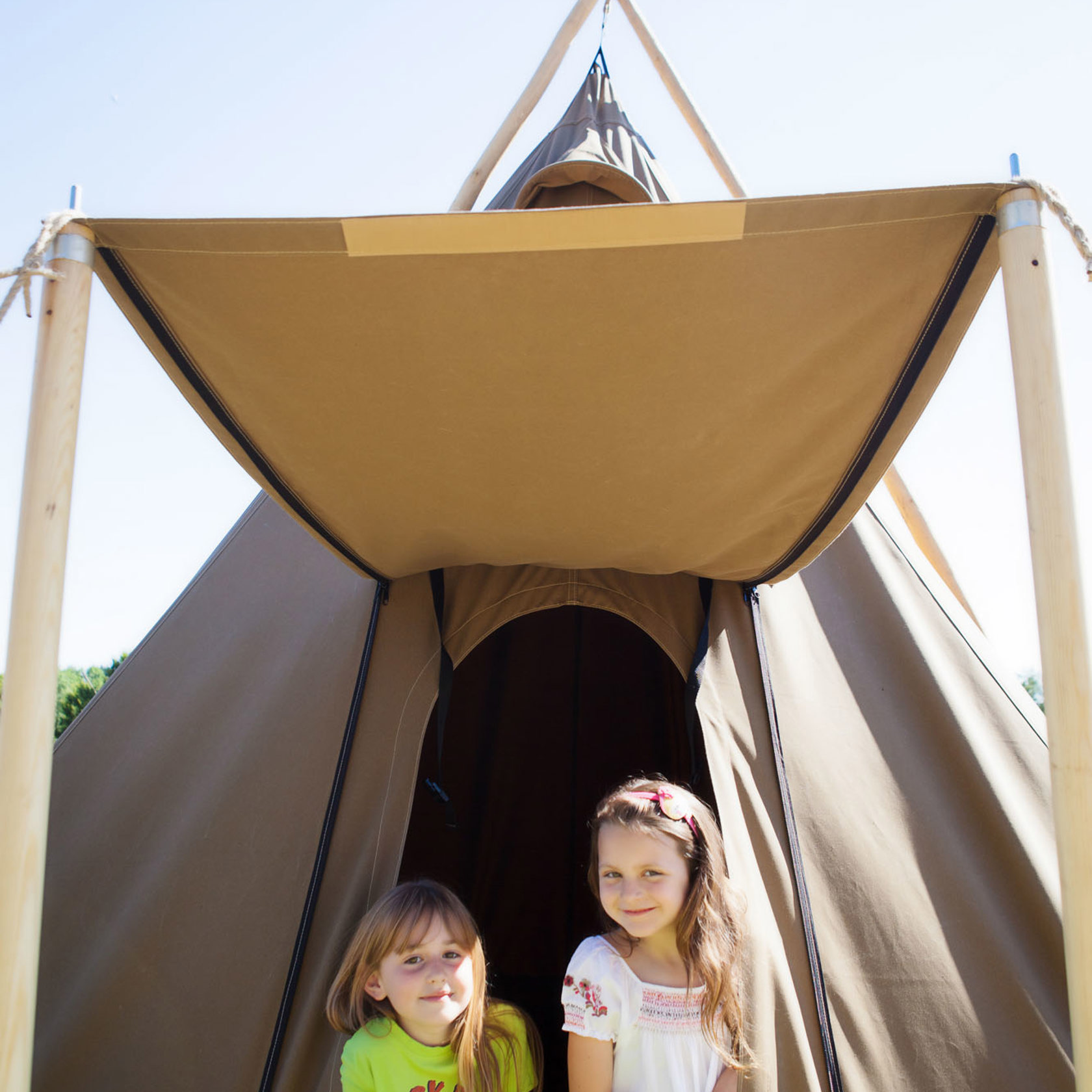 Two young girls in a teepee at Durrell Wildlife Camp